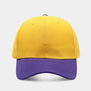 Close-up of two-tone baseball cap in yellow and purple with detailed twill cotton texture