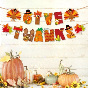 Detail of Give Thanks hanging banner with turkey and pumpkin motifs for party decor