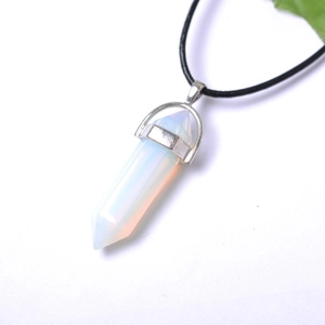Detailed macro view of an opal hexagonal crystal pendant necklace with a black cord strap