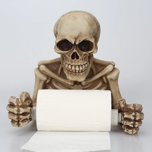 Detail of vintage resin skeleton toilet paper holder with gothic bone texture and design