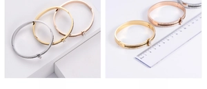 Three-color crystal bangle set with sizing ruler showing dimensions and closure detail