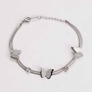 Macro detail of silver double-layer chain bracelet with frosted butterflies and rhinestones