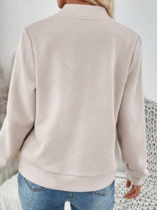 Detailed back view of women's apricot knit top with unique geometric embossed texture