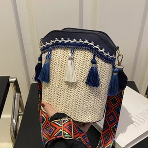 Minimalist woven bucket bag in cream with blue leather trim and tassel detailing