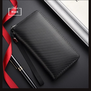 Detailed view of black carbon fiber wallet with zipper and lanyard on silk background