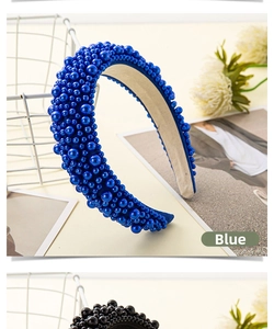 Close-up of blue faux pearls in various sizes on a wide luxury headband with fabric wrap