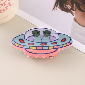 Detailed view of creative UFO hair claw clip with cute green aliens and vibrant patterns