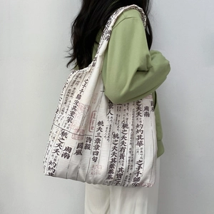 Detail of vintage canvas tote bag featuring Shijing calligraphy on off-white fabric