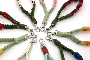 Macro detail of handmade woven flower keychains with various colorful bohemian patterns