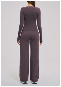 Rear view of purple yoga set featuring a slim long sleeve top and high waist wide leg pants
