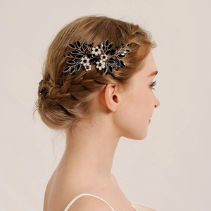 Vintage bridal hair comb with black crystals and pearls on elegant wedding hairstyle