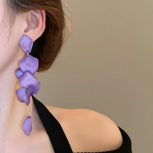 Close-up of elegant purple resin petal tassel earrings worn by a female model