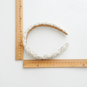 French vintage tweed headband with black and white woven texture on a plain background