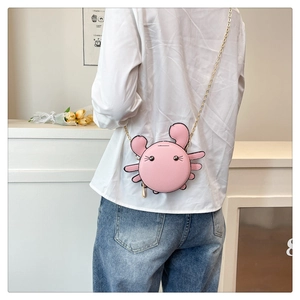 Close-up of a cute pink crab-shaped mini crossbody bag with a golden chain strap
