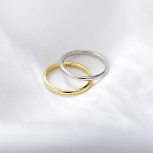 Minimalist 925 sterling silver and 14K gold plated plain rings on white silk