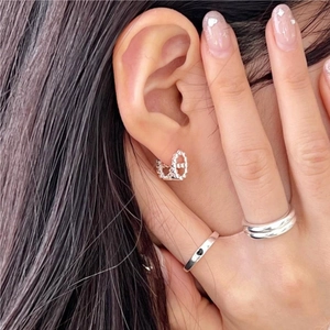 Detailed view of 925 silver link earrings and zircon rings on model for daily style