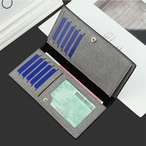 Macro detail of grey canvas men's wallet showing card slots and ID window layout