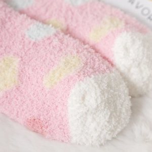 Thick pink coral fleece socks with yellow polka dots and plush texture for winter warmth