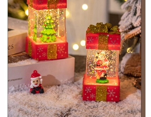 Detail of red Christmas gift box lanterns with Santa and tree motifs in a festive setting