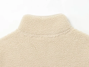 Detail view of beige fleece sweater collar with high neck stitching and plush texture