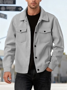 Detail of light gray corduroy shirt jacket featuring textured fabric and chest pockets