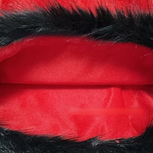 Macro detail of red woven fabric and black faux fur texture for Christmas decoration