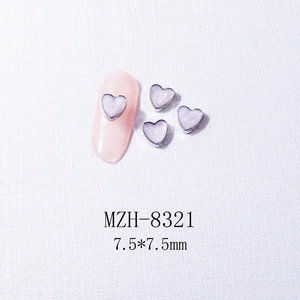 Detailed 7.5x7.5mm lavender heart nail charms with metal edge on a pink nail tip