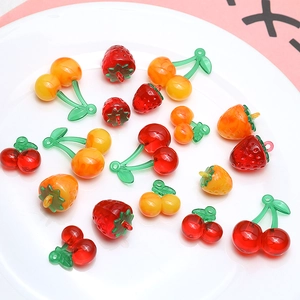 Detail of sweet resin fruit pendants featuring strawberries and cherries for DIY jewelry