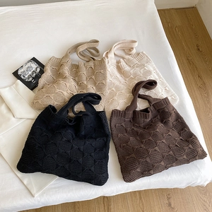Detailed flat lay of four knit tote bags in black brown khaki and cream colors