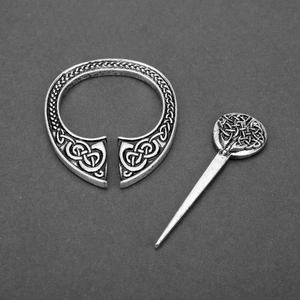 Macro shot of antique silver Celtic penannular brooch with Tree of Life engraving
