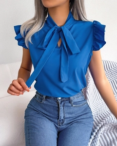 Detail of navy blue sleeveless chiffon blouse with bow neck and ruffle shoulder design