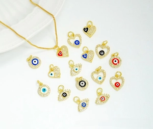 Macro detail of 18K gold plated evil eye charms with micro-pave cubic zirconia crystals