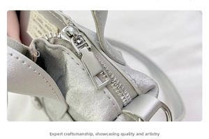 Detailed macro view of silver metal zipper and interior casual pouch woven label