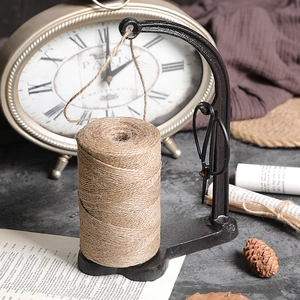 Vintage cast iron twine holder with jute rope and scissors for rustic home decor