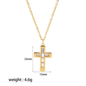 Macro shot of 18k gold cross pendant with cubic zirconia inlay and 22mm x 15mm dimensions