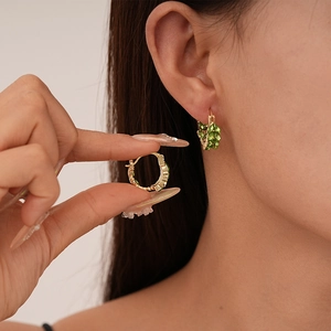 Elegant gold wheat-shaped hoop earrings with marquise-cut green cubic zirconia stones
