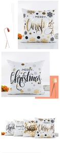 Close-up of modern Christmas pillow covers with gold foil lettering and snowflake patterns
