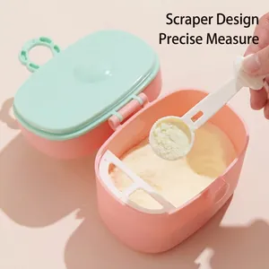 Portable baby formula dispenser with scraper and spoon in pink and mint green colors
