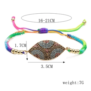 Detail of adjustable colorful woven evil eye bracelet with sparkling rhinestone charm