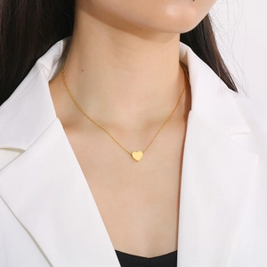 Golden titanium steel heart pendant necklace with infinity symbol on a model