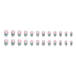 French tip press-on nails with green hearts and pearl accents on nude pink base