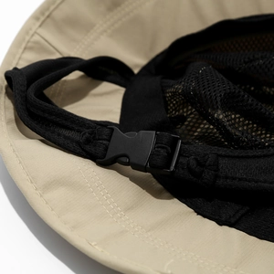 Detail of outdoor sun hat featuring adjustable plastic buckle and breathable mesh fabric