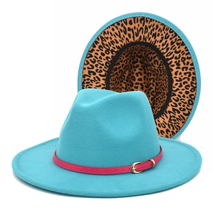 Detail of teal wool fedora hat featuring leopard print lining and magenta belt buckle