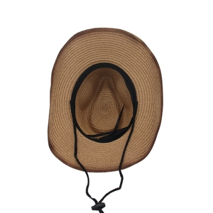 Detail view of woven straw hat featuring black sweatband and adjustable chin strap
