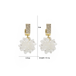 Detail view of white shell flower earrings with tassel and dimensions of 4cm by 2.5cm