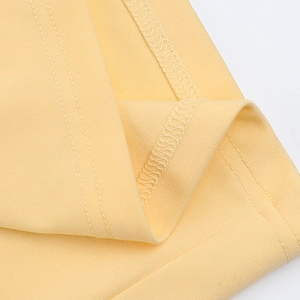 Detailed close-up showing bright yellow knitted fabric texture and precise stitching detail