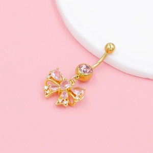 Pink butterfly belly button ring in gold finish with crystals on pink background