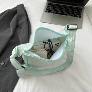 Fashionable light green bubble textured crossbody bag showing spacious interior capacity