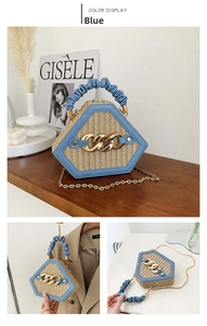 Detail of blue hexagonal straw handbag featuring gold chain and ruffled handle