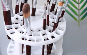 Detail view of a white circular makeup brush holder with multiple holes for storage
